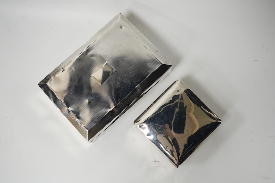 Two silver engraved cigarette boxes (a.f.). largest 16.6cm. Condition - poor